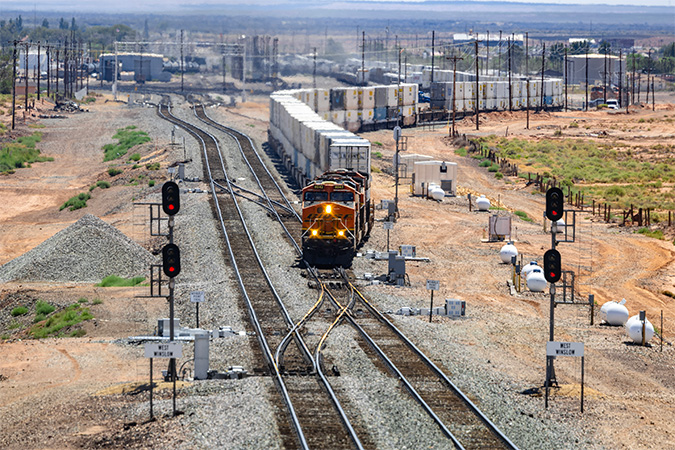 A westbound intermodal train departs Winslow from one of the new tracks.